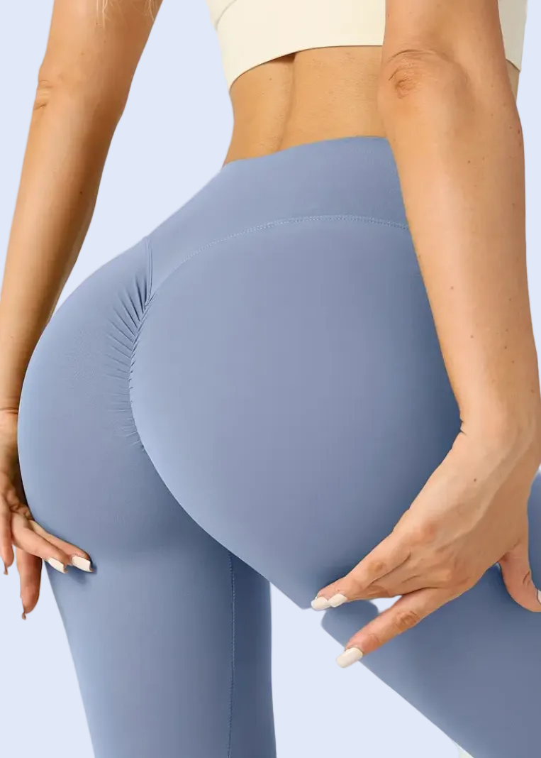 Blue leggings worn by a person on a plain background