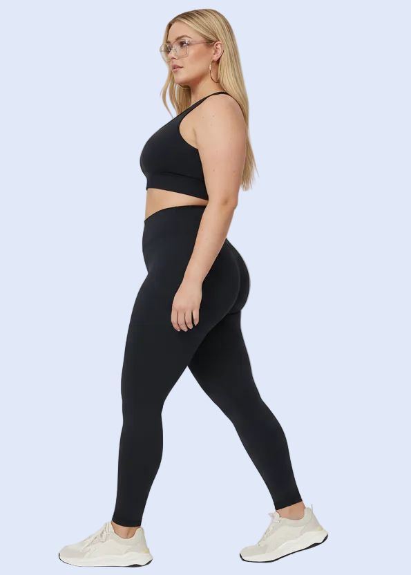 Person wearing black leggings on a gray background