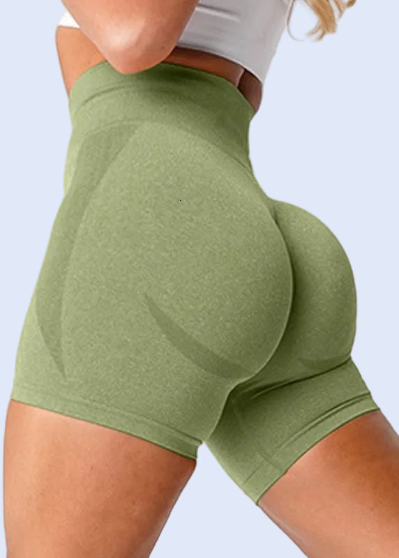 Green athletic shorts worn by a person on a white background