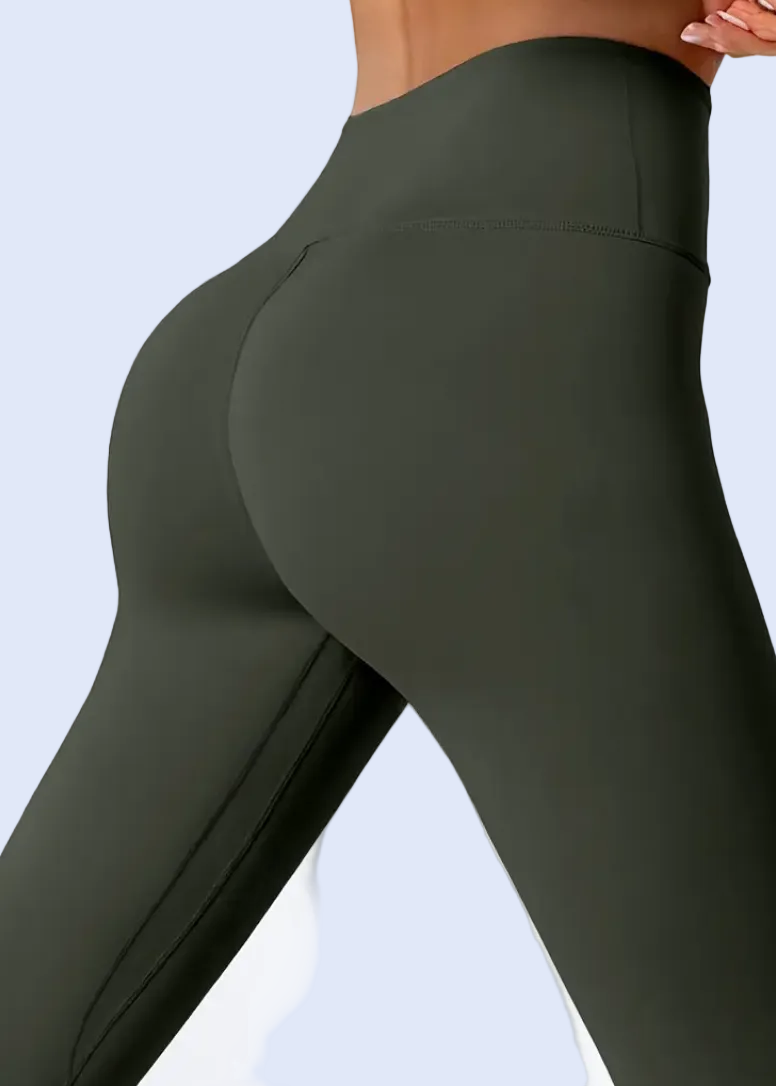 Dark green leggings worn by a person on a white background