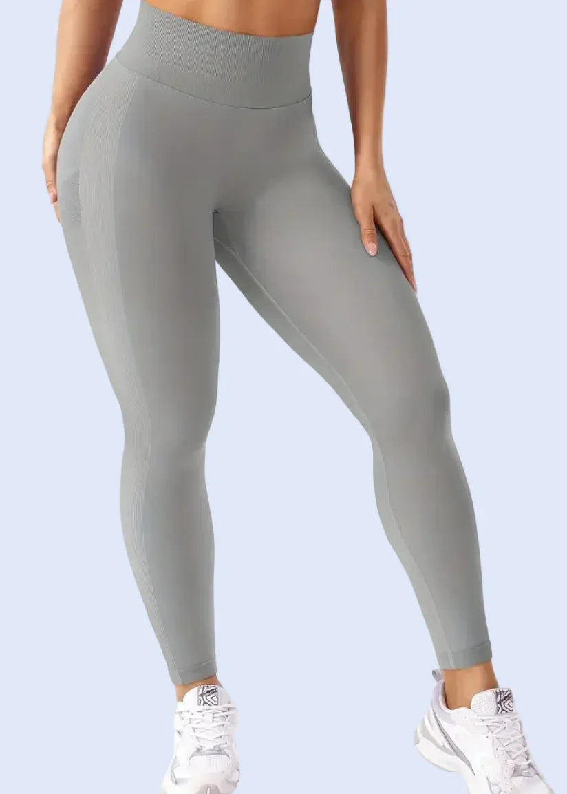 Person wearing gray leggings on a white background