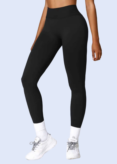 Person wearing black leggings on a white background