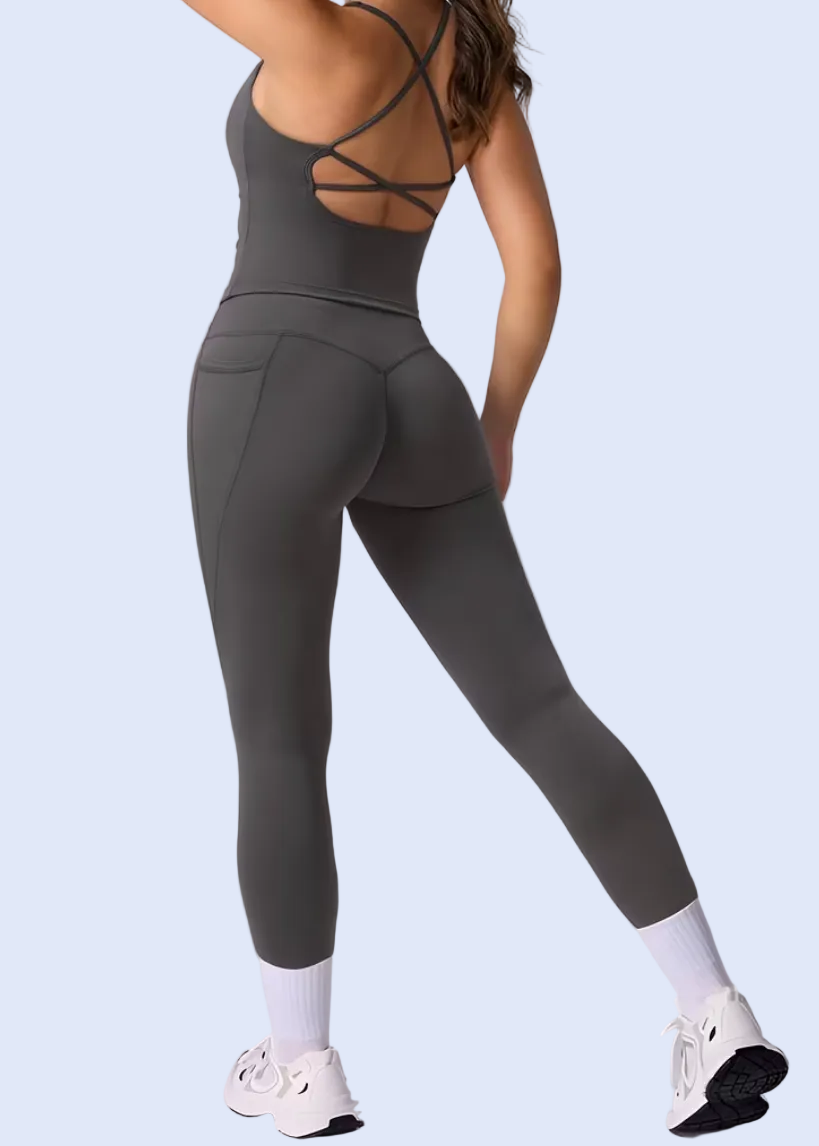 Person wearing a gray jumpsuit on a white background