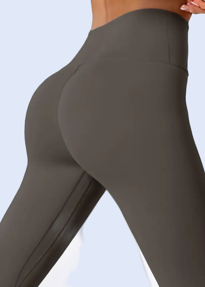 Dark gray leggings worn by a person on a white background