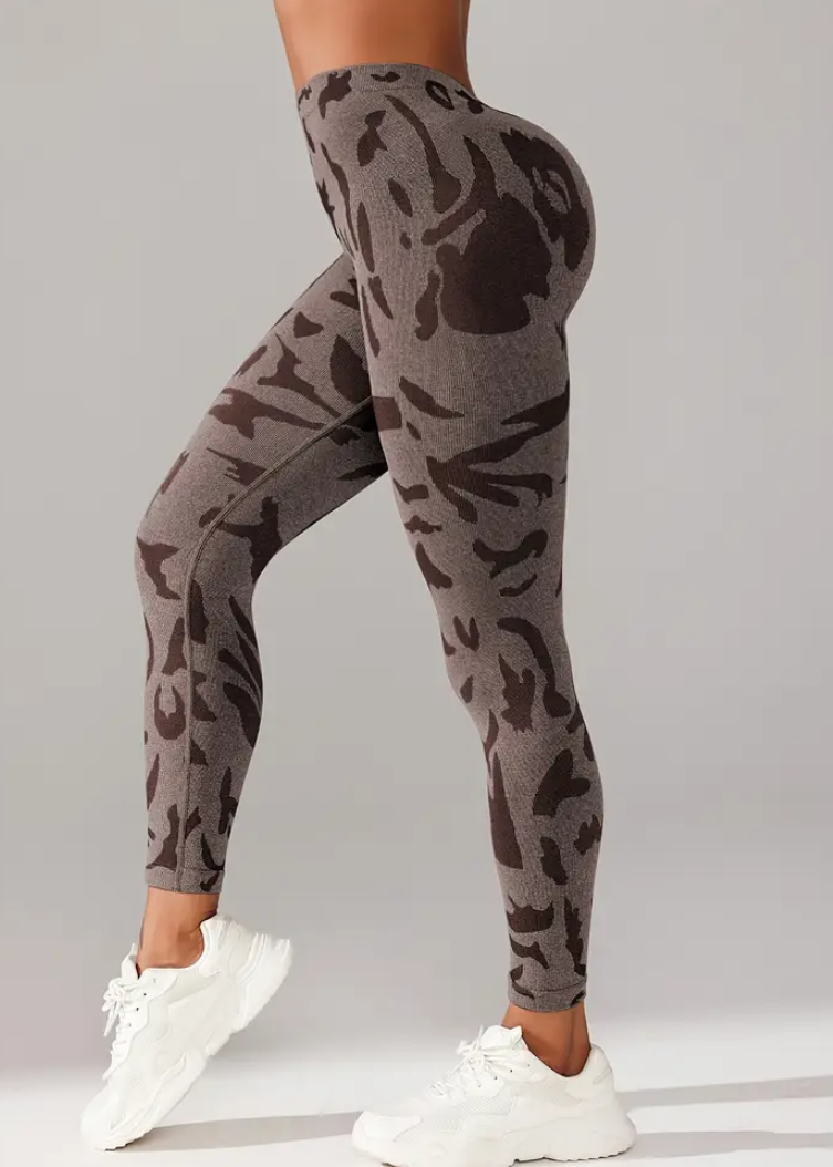 Camouflage leggings worn by a person on a gray background
