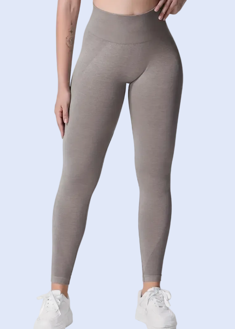 Person wearing gray leggings on a white background