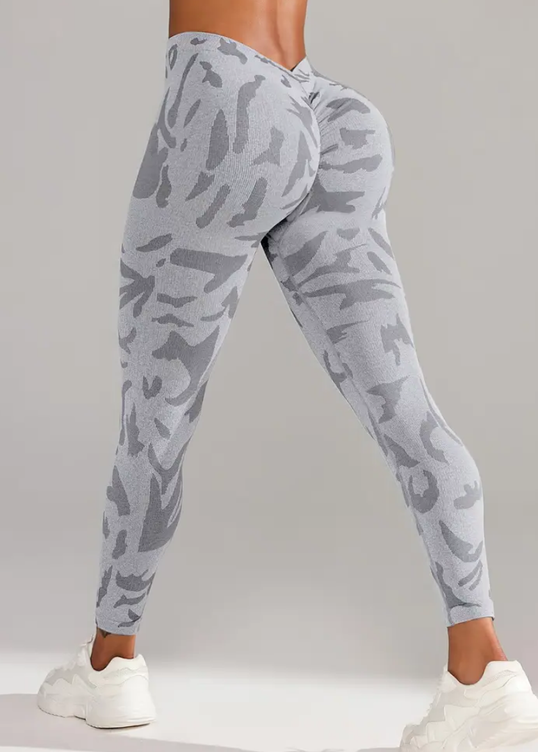 Gray camouflage leggings worn by a person on a plain background