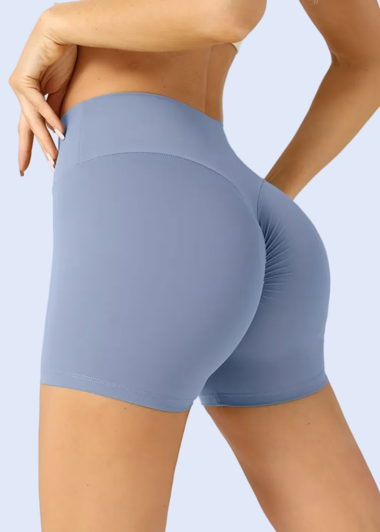 Blue athletic shorts worn by a person on a plain background