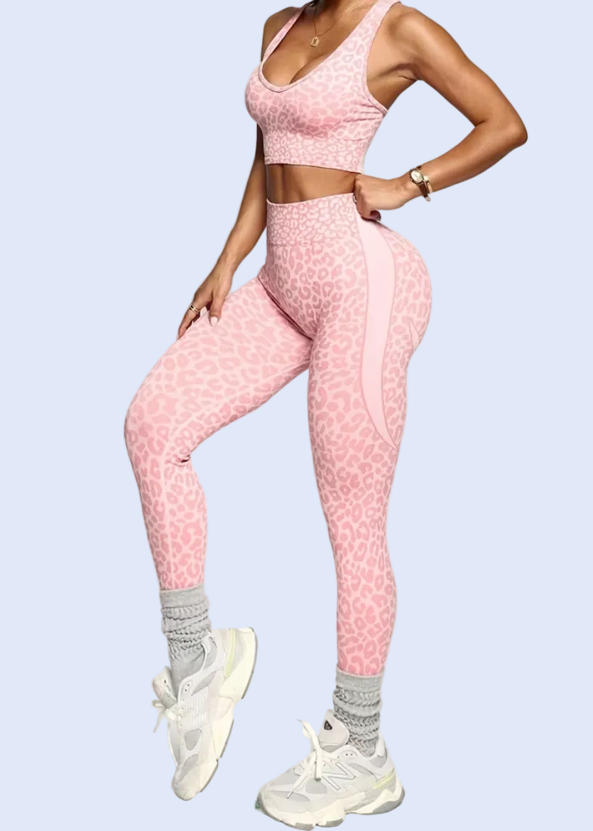 Person wearing a pink athletic outfit on a white background