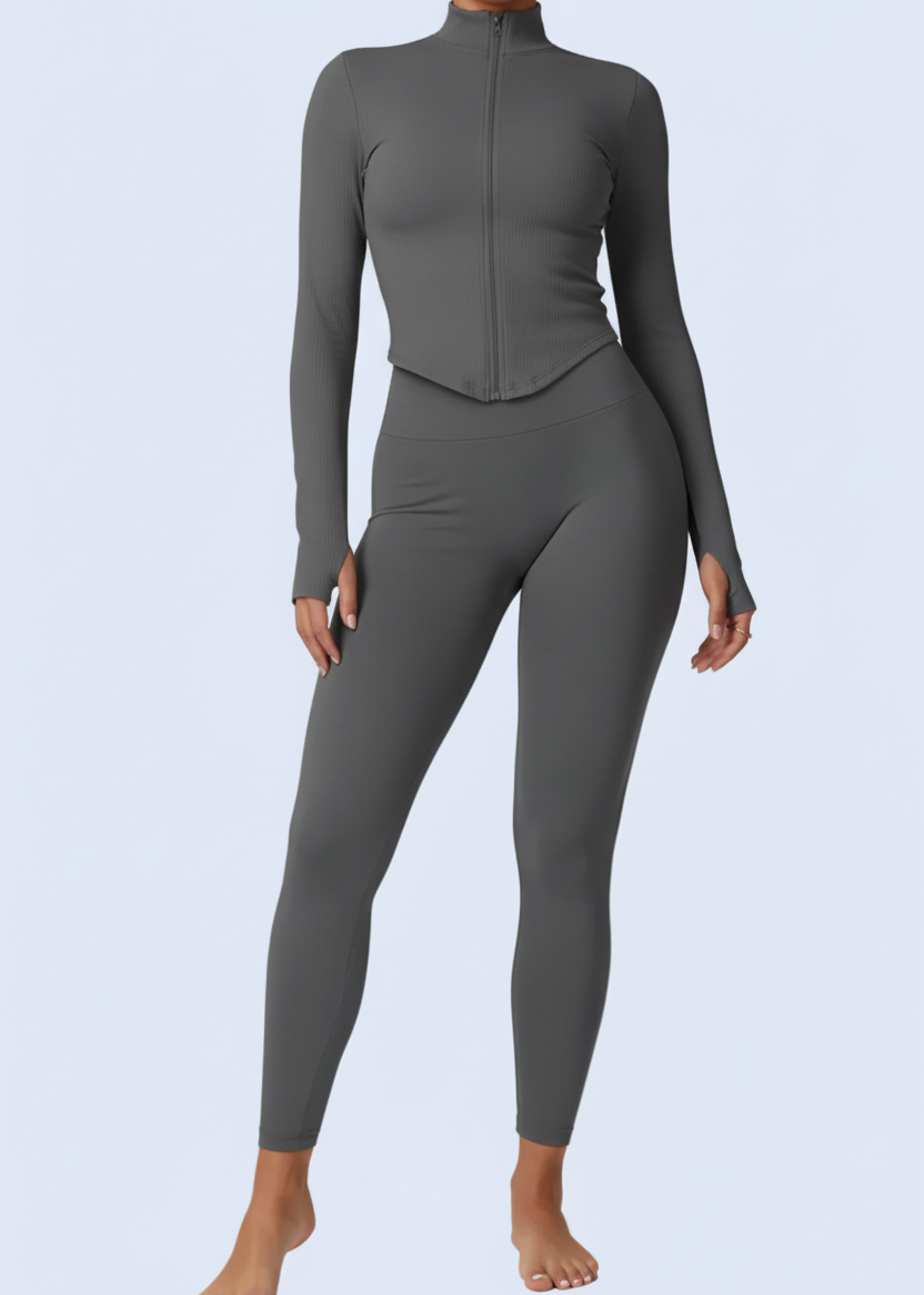 Person wearing a gray jumpsuit on a white background with product details at the bottom.