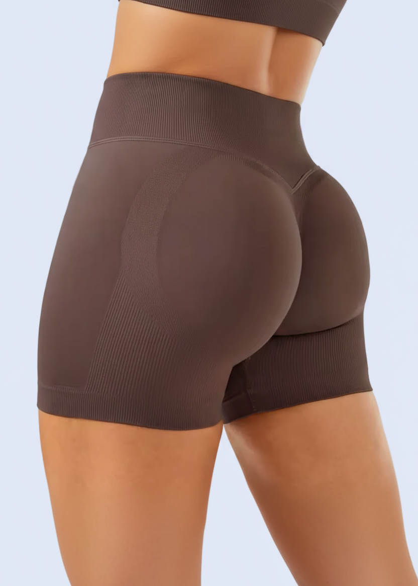 Brown athletic shorts on a person with NCLAGEN branding, displayed on a smartphone screen.