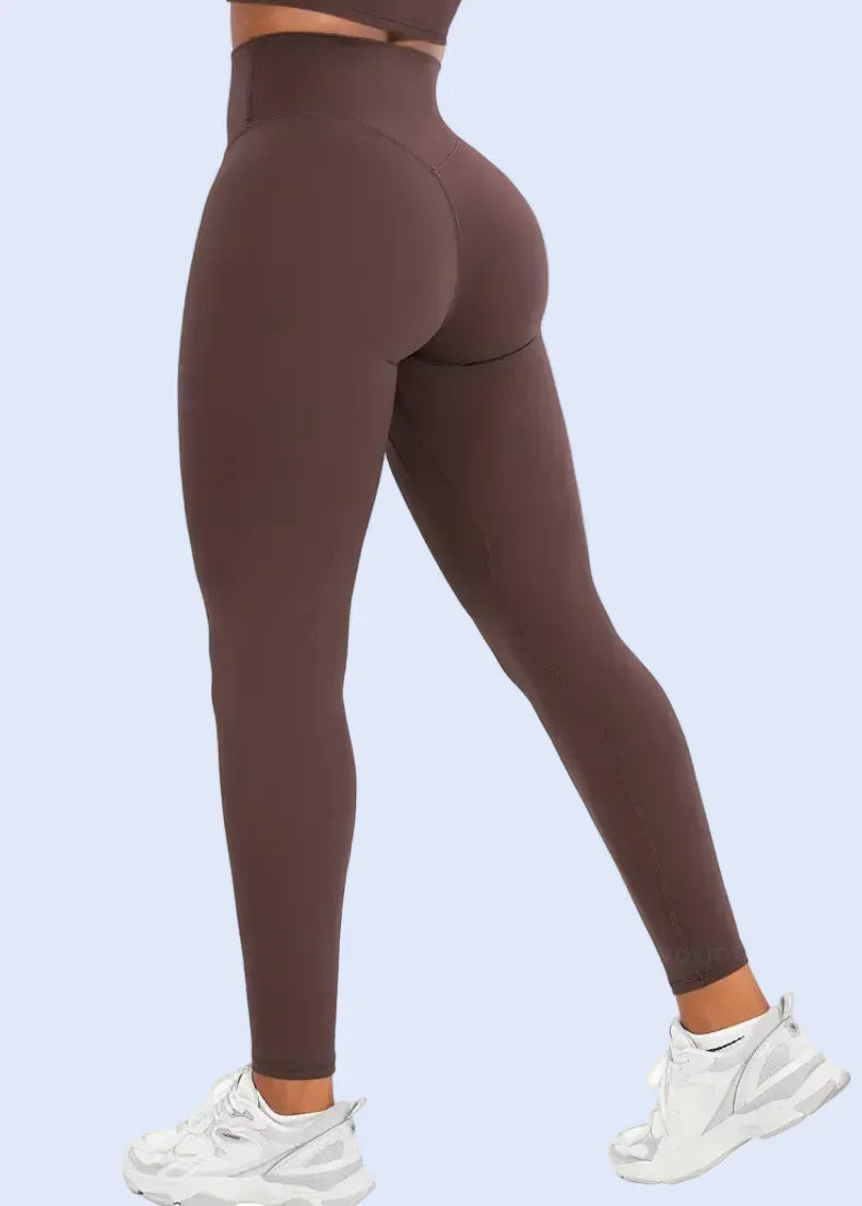 Brown leggings worn by a person on a white background