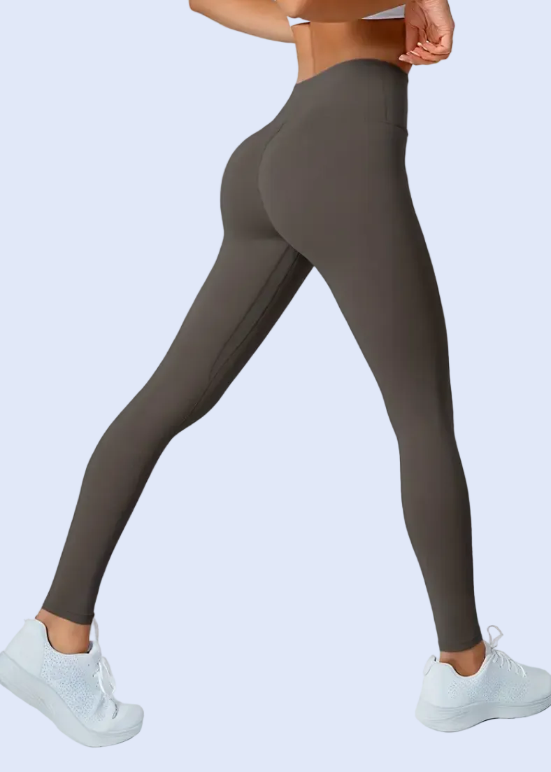 Dark gray leggings worn by a person on a white background