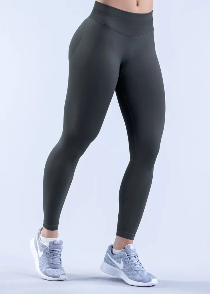 Person wearing black leggings on a white background