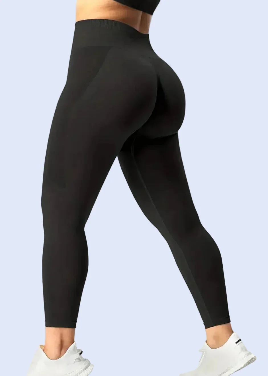 Woman wearing high-waisted black seamless leggings and white sneakers, GymDeity activewear