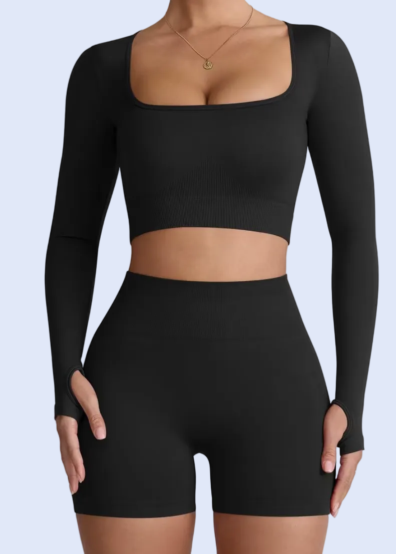Black long-sleeve crop top and high-waisted shorts on a white background