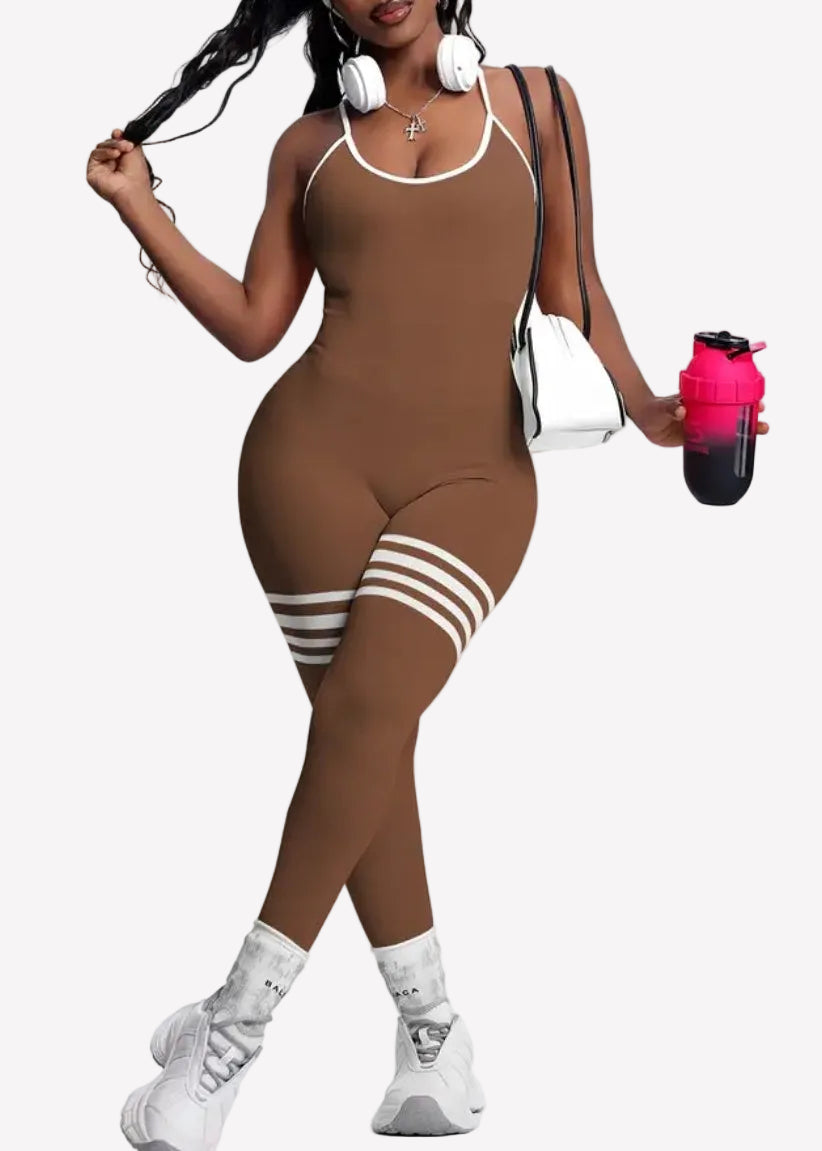 Woman in a brown outfit with white accents holding a water bottle on a white background