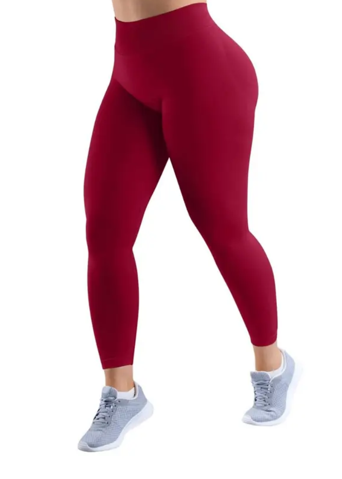 Red leggings worn by a person on a white background