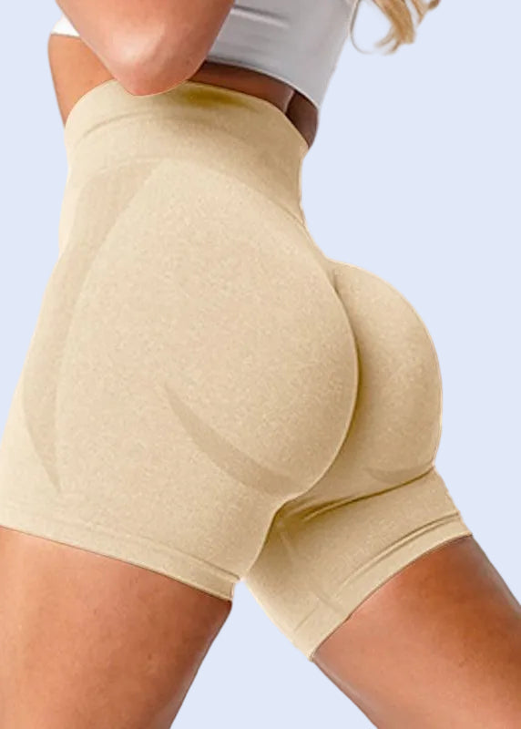 Beige shapewear shorts worn by a person on a white background