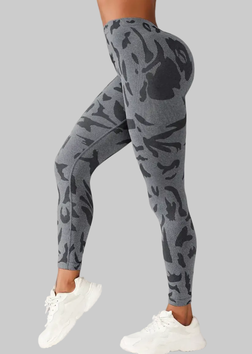 Gray camouflage leggings worn by a person on a gray background