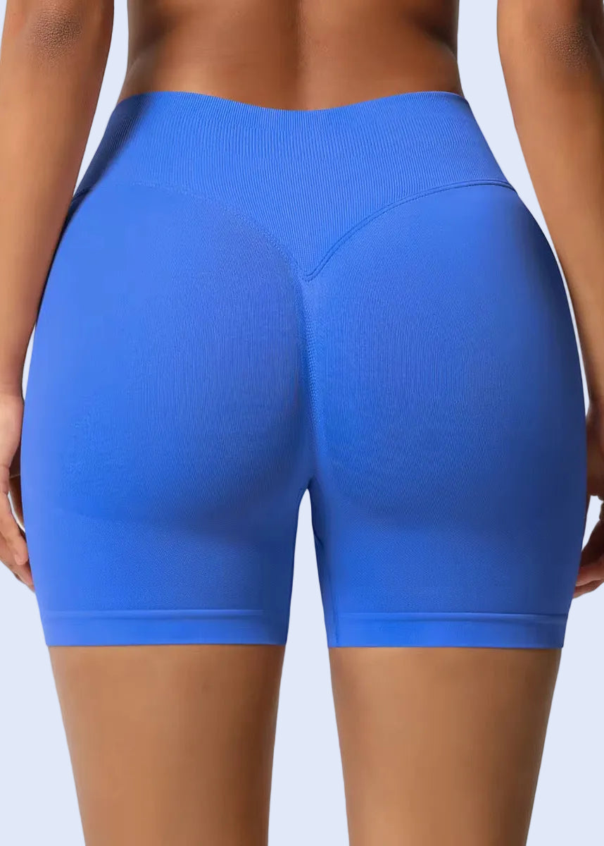 Blue athletic shorts worn by a person on a plain background