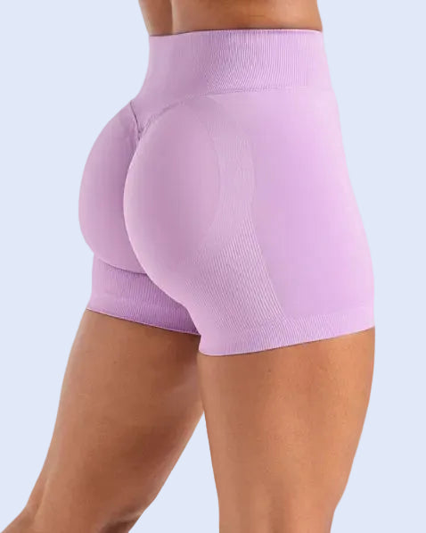 Purple athletic shorts worn by a person on a white background