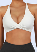 White sports bra and black leggings on a person against a white background