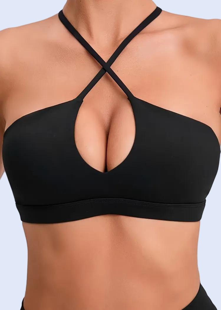 Black sports bra on a person against a light gray background