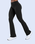 Black high-waisted flared leggings shown on a model from the waist down, paired with white sneakers, against a light blue background.