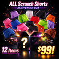 Colorful women's scrunch shorts surround a mystery activewear box, 12 items for $99 at GymDeity.