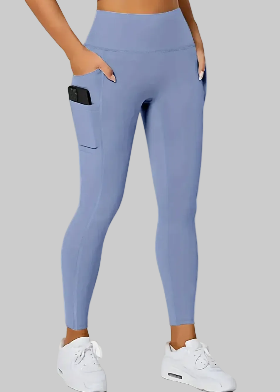Person wearing blue leggings with a pocket on a beige background