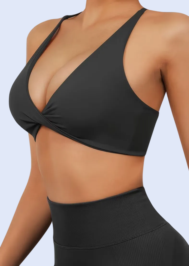 Black sports bra and leggings on a model with a white background