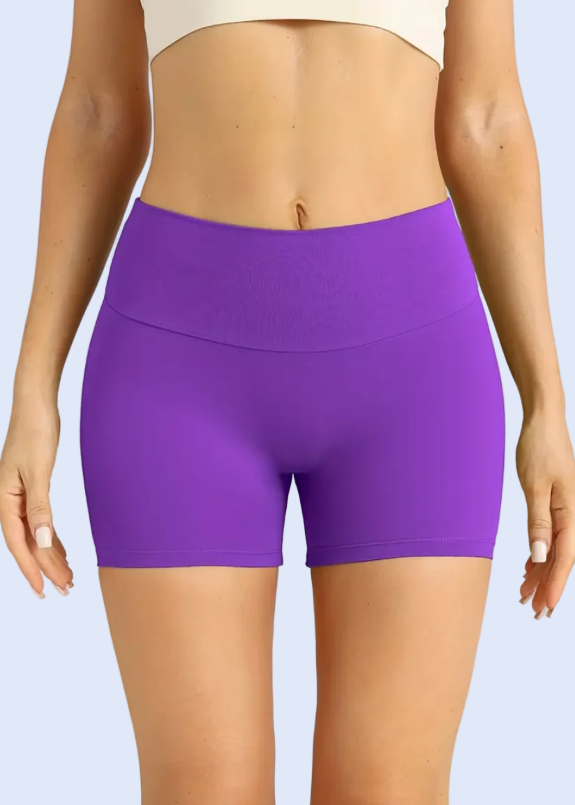 Purple shorts worn by a person on a plain background