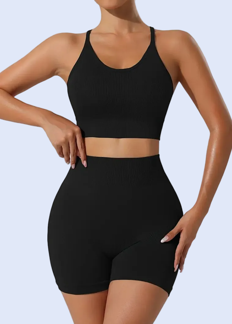 Person wearing a black athletic outfit on a plain background