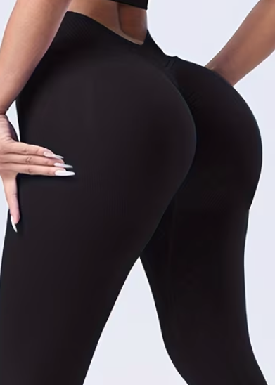 Person wearing black leggings on a white background
