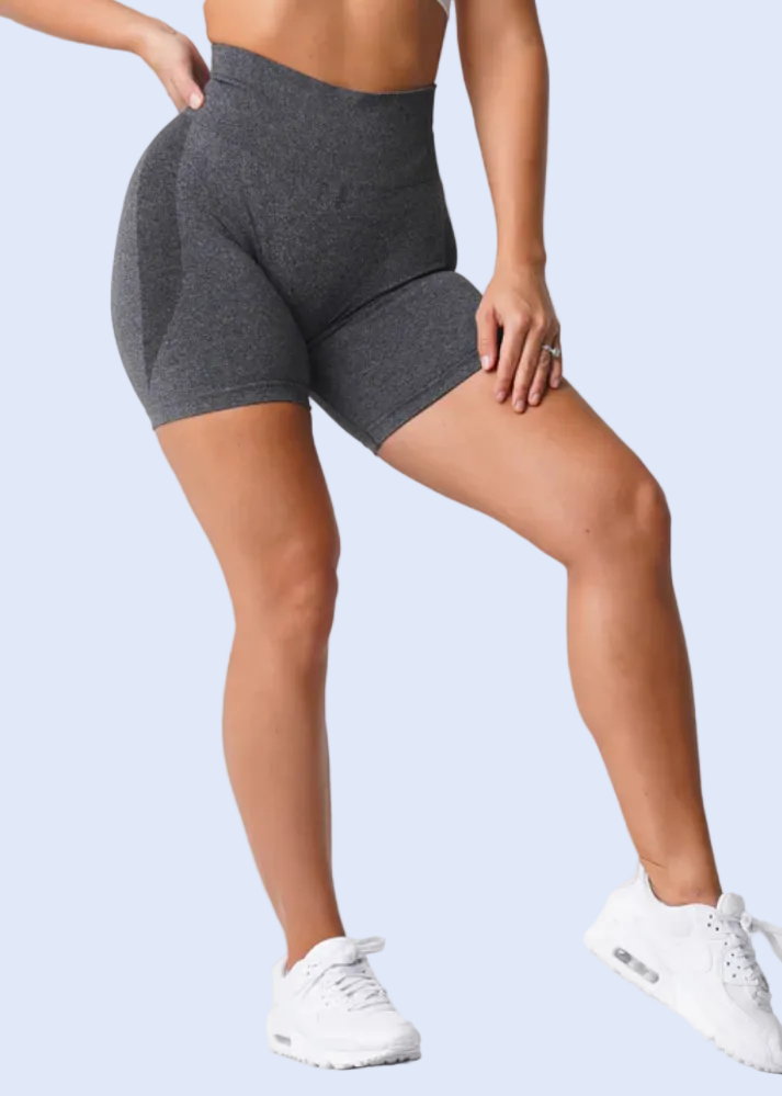 Person wearing gray spandex shorts with a white top on a white background, with additional images of the shorts displayed below.