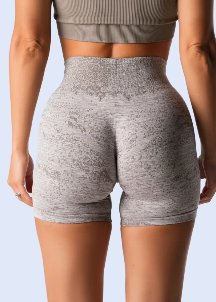 Person wearing gray high-waisted shorts on a white background