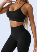 Person wearing a black sports bra and leggings on a light gray background