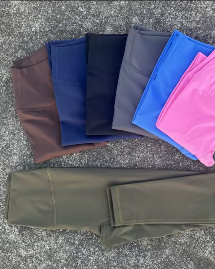 Folded leggings in various colors on a textured surface