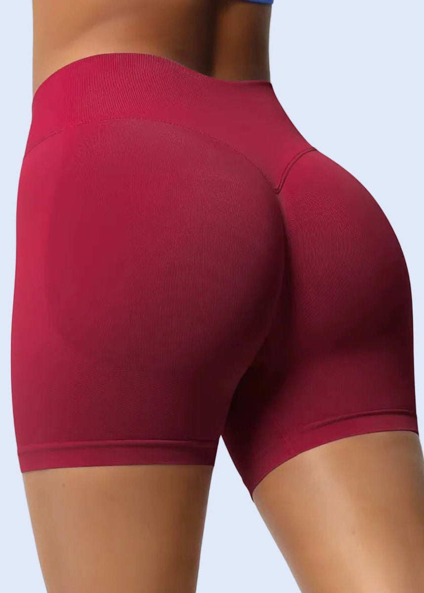 Maroon athletic shorts worn by a person on a light gray background