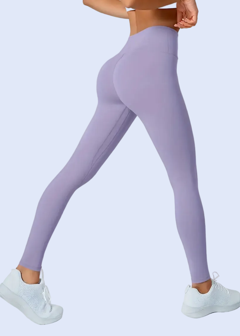 Person wearing purple leggings on a white background