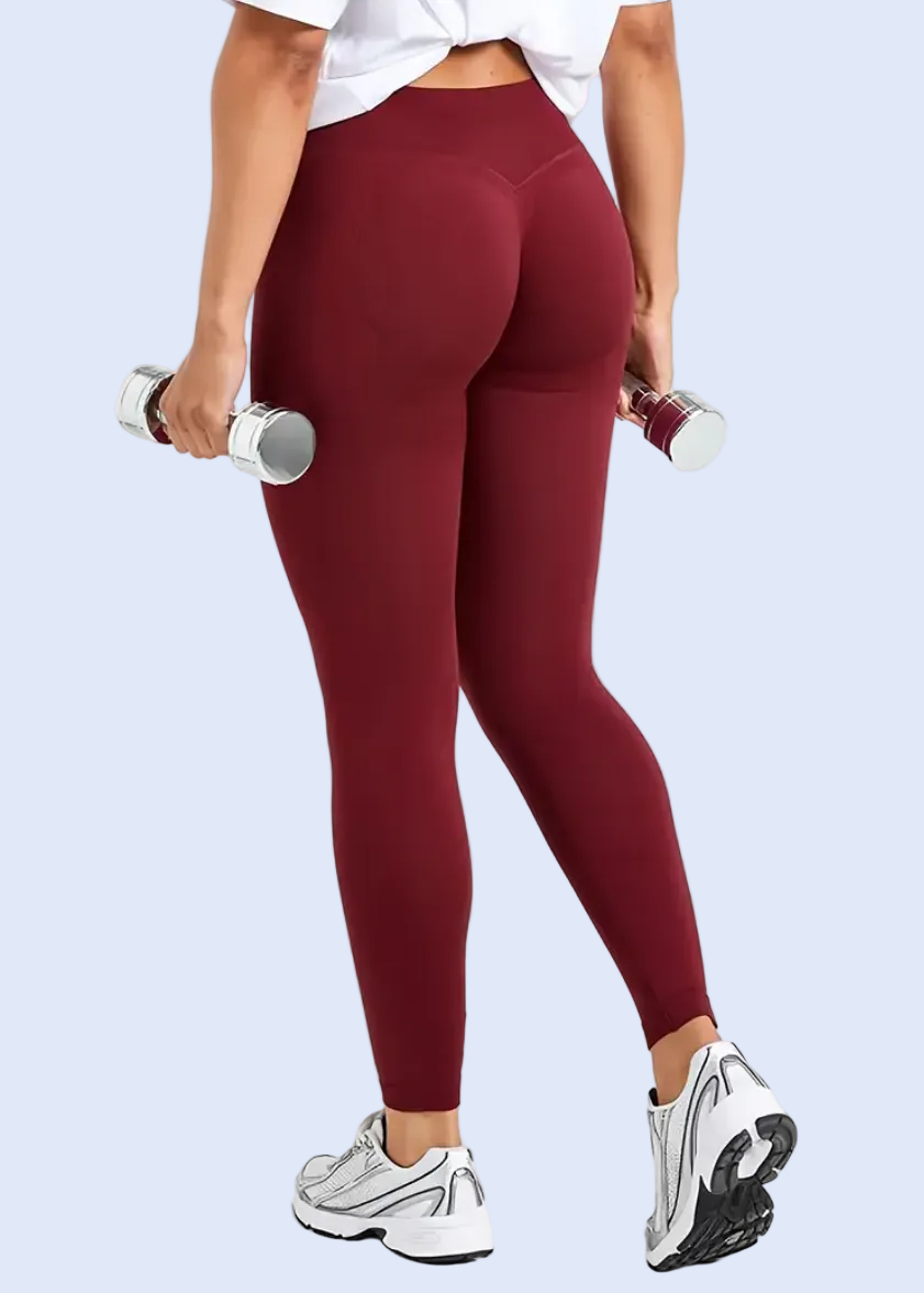 Person wearing maroon leggings on a white background