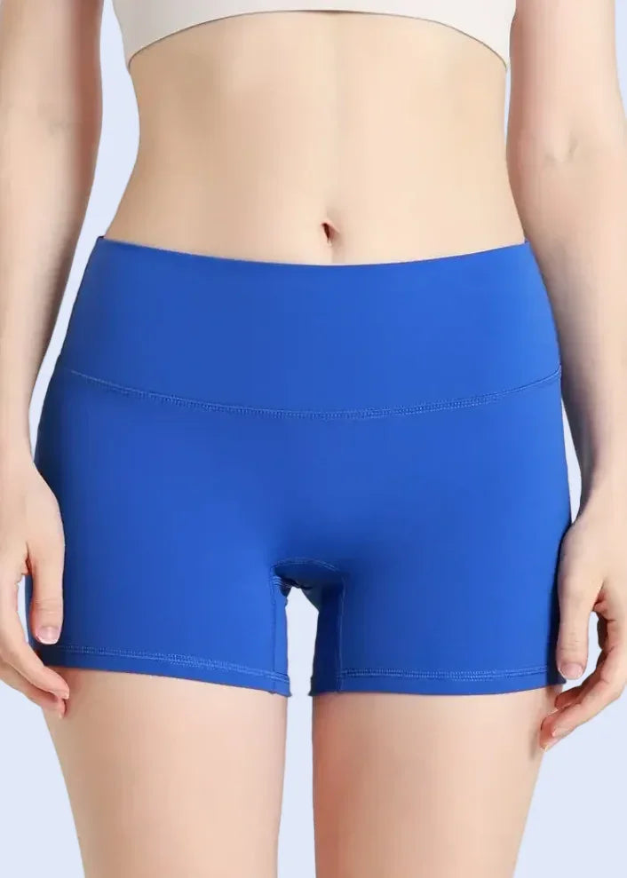 Person wearing blue shorts on a plain background