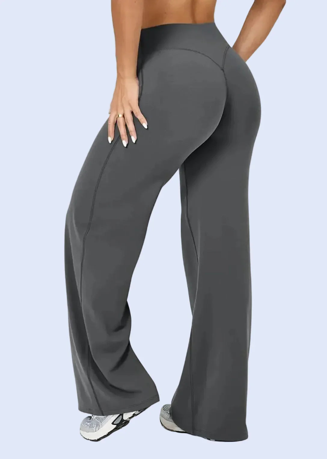 Woman wearing dark gray high-waisted flared activewear pants from GymDeity