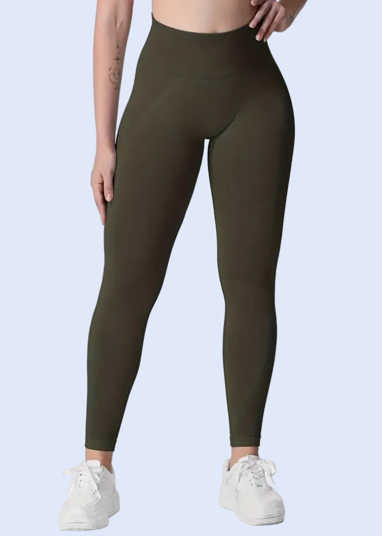 Person wearing olive green leggings on a white background