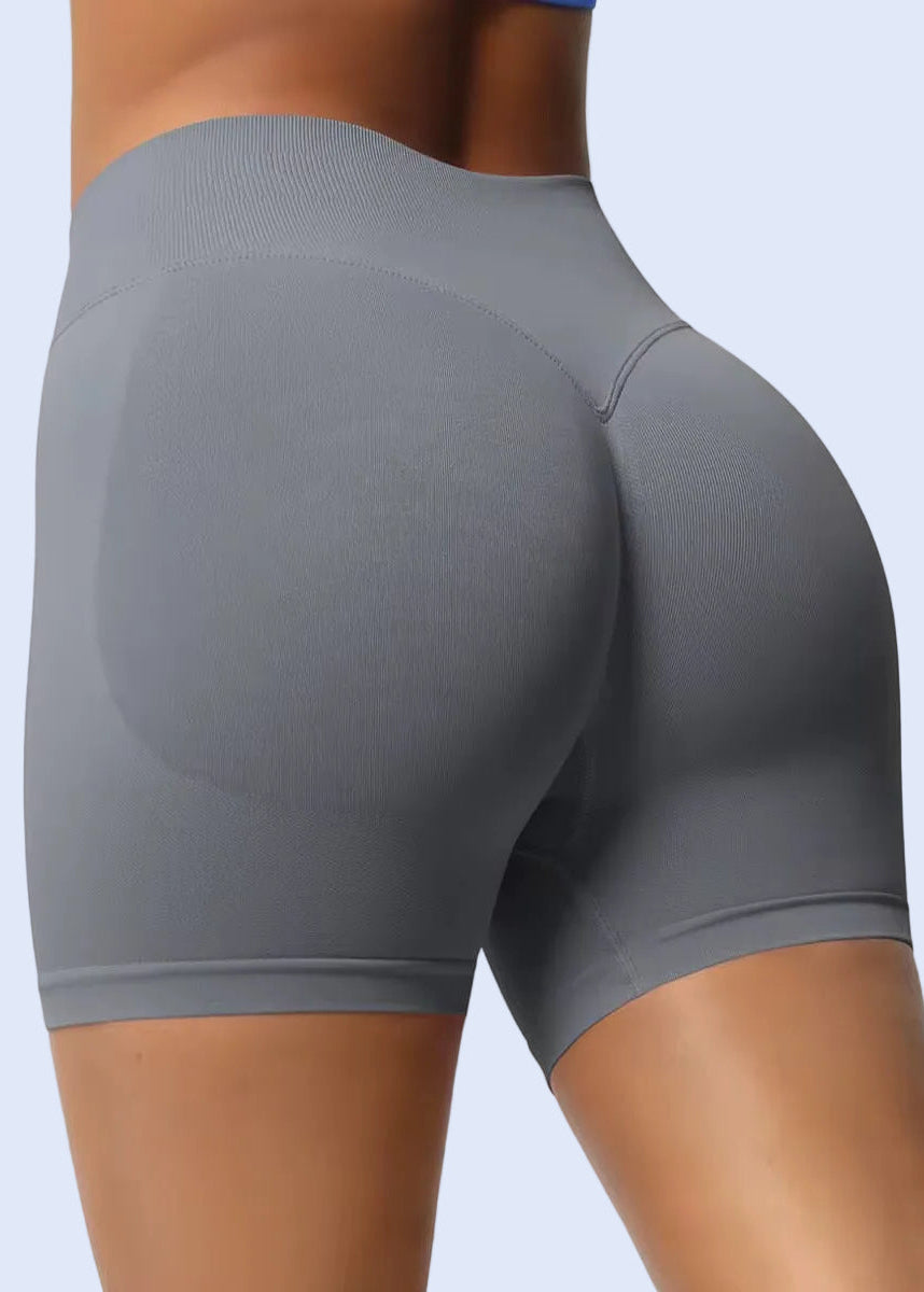 Gray athletic shorts worn by a person on a plain background