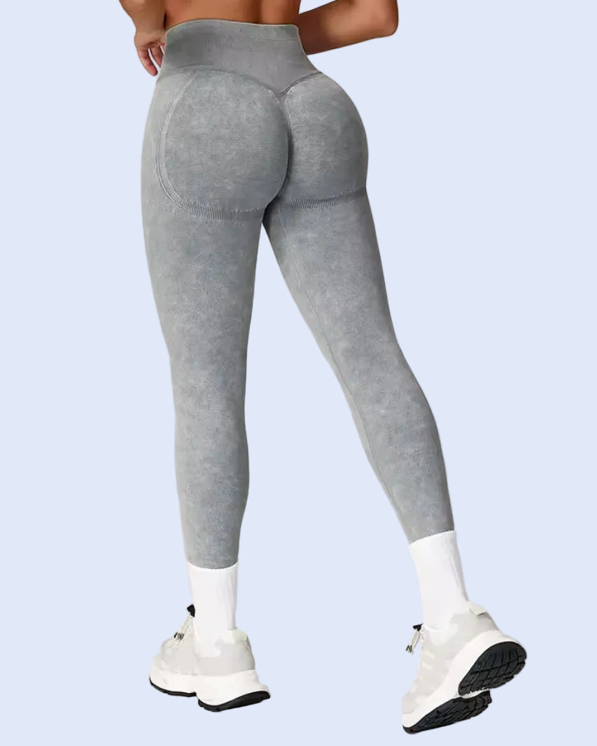 Gray leggings worn by a person on a plain background