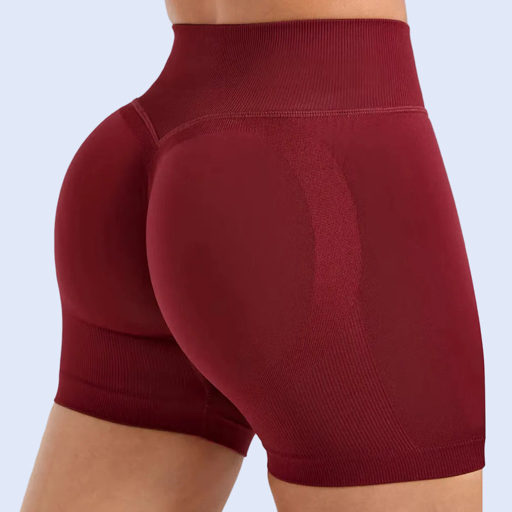 Maroon athletic shorts on a white background