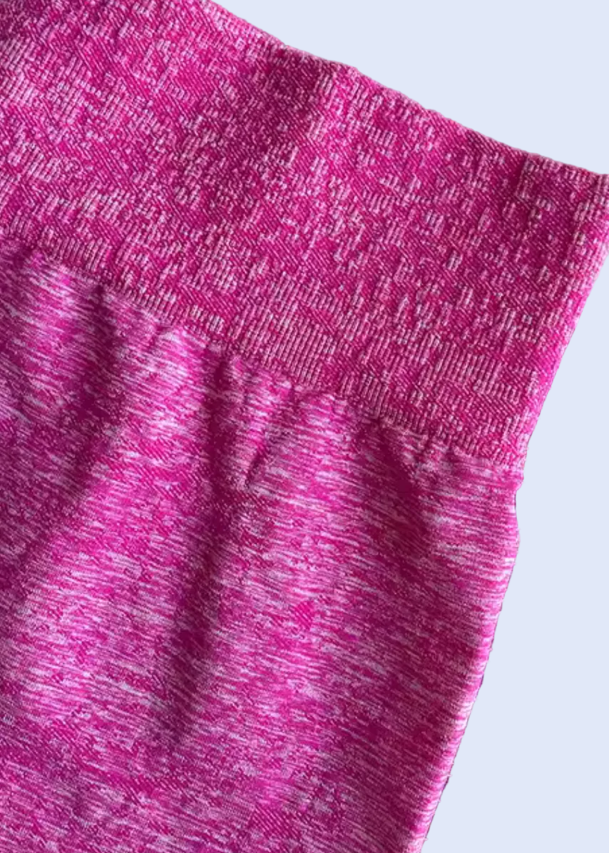 Close-up of pink shorts with a textured pattern on a gray background, displayed on a smartphone screen.