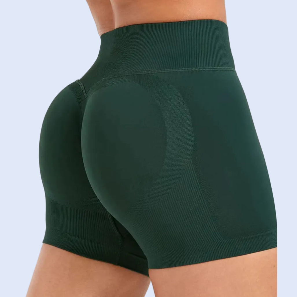 Green athletic shorts worn by a person on a white background